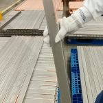 engineer-holding-titanium-clad-bus-bar-side