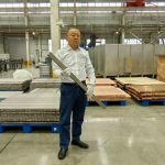 engineer-warehouse-widescreen-holding-bus-bar